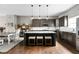 Stylish kitchen with an island, dark cabinetry, subway tile backsplash, and modern pendant lighting at 863 N Park Trail Dr, Carmel, IN 46032