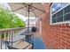 Cozy patio with red brick, umbrella and chair for outdoor dining and relaxing at 863 N Park Trail Dr, Carmel, IN 46032
