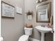 Stylish powder room with pedestal sink, decorative accents, and modern fixtures at 863 N Park Trail Dr, Carmel, IN 46032