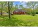 Expansive backyard featuring a well-manicured lawn and a charming red home at 8636 Rockville Rd, Indianapolis, IN 46234