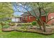 Charming backyard showcasing a red house, stone features, and healthy green lawn at 8636 Rockville Rd, Indianapolis, IN 46234