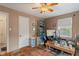 Bright bedroom with light-colored walls and wood flooring, showcasing a ceiling fan at 8636 Rockville Rd, Indianapolis, IN 46234