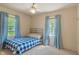 Bright bedroom with a blue and white checkered bedspread and curtains at 8636 Rockville Rd, Indianapolis, IN 46234