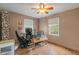 Inviting bedroom with light-colored walls and wood flooring, featuring a ceiling fan at 8636 Rockville Rd, Indianapolis, IN 46234