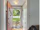 Inviting entryway with a solid wood door and views of the bright outdoors at 8636 Rockville Rd, Indianapolis, IN 46234