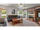 Comfortable living room with a fireplace, cozy seating, and bright windows at 8636 Rockville Rd, Indianapolis, IN 46234