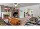 Cozy living room featuring a fireplace, dark leather furniture, and abundant natural light at 8636 Rockville Rd, Indianapolis, IN 46234