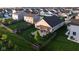 Aerial view showcasing a home with a fenced backyard featuring a patio, pergola, fire pit, and landscaping at 934 Steel Horse Dr, Westfield, IN 46074