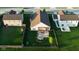 Aerial view of a well-maintained home featuring a patio with pergola, fire pit, and lush green lawn at 934 Steel Horse Dr, Westfield, IN 46074