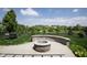 Beautiful backyard with a stone fire pit, lush green grass, and mature trees, perfect for outdoor enjoyment at 934 Steel Horse Dr, Westfield, IN 46074