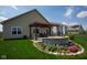 Landscaped backyard features a pergola over a stone fire pit and patio perfect for outdoor relaxation at 934 Steel Horse Dr, Westfield, IN 46074