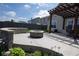 Inviting backyard featuring a stone fire pit, patio with pergola, and landscaped garden for relaxing outdoor gatherings at 934 Steel Horse Dr, Westfield, IN 46074