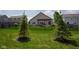 The backyard has an outdoor patio with a pergola and a beautifully landscaped lawn at 934 Steel Horse Dr, Westfield, IN 46074