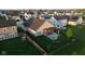 Aerial view of fenced backyard with patio, pergola, fire pit, and manicured lawn at 934 Steel Horse Dr, Westfield, IN 46074
