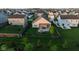 Aerial view of fenced backyard with patio, pergola, fire pit, and beautifully landscaped lawn at 934 Steel Horse Dr, Westfield, IN 46074