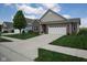 Well-maintained home boasting a lush green lawn and concrete driveway leading to a two-car garage at 934 Steel Horse Dr, Westfield, IN 46074