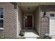 Inviting front door entrance with brick accents, decorative plants, and a secure Guardian security sign at 934 Steel Horse Dr, Westfield, IN 46074