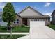 Charming brick home featuring a well-manicured lawn and attached two car garage at 934 Steel Horse Dr, Westfield, IN 46074