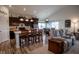 Open-concept kitchen featuring a breakfast bar, dark cabinetry, and seamless flow into the living area at 934 Steel Horse Dr, Westfield, IN 46074