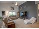 Comfortable living room with a gray accent wall, ample seating, and bright natural light from the windows at 934 Steel Horse Dr, Westfield, IN 46074