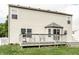 Exterior back view of home featuring a spacious deck with a cozy seating area for outdoor relaxation at 941 Pine Ridge Way, Brownsburg, IN 46112