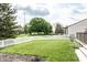 Well-maintained lawn with mature trees and white picket fence at 941 Pine Ridge Way, Brownsburg, IN 46112