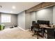 Finished basement area with an exposed beam, carpeted floor, and desk area at 941 Pine Ridge Way, Brownsburg, IN 46112