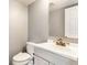 Clean half-bathroom featuring a modern vanity, sink, and neutral decor at 941 Pine Ridge Way, Brownsburg, IN 46112