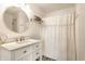 Bright bathroom featuring a stylish vanity, mirror, and shower with white shower curtain at 941 Pine Ridge Way, Brownsburg, IN 46112