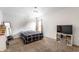 Neutral bedroom with bed, TV, and shelving for storage at 941 Pine Ridge Way, Brownsburg, IN 46112