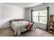 Bright bedroom features neutral tones, a large window, and cozy carpeting at 941 Pine Ridge Way, Brownsburg, IN 46112