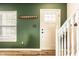 Welcoming entryway features stylish wood flooring, a coat rack, and a staircase at 941 Pine Ridge Way, Brownsburg, IN 46112