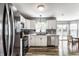 Bright kitchen open to dining area, showcasing stainless steel appliances and ample natural light at 941 Pine Ridge Way, Brownsburg, IN 46112