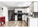 Well-lit kitchen featuring white cabinets, modern appliances, and a stylish backsplash at 941 Pine Ridge Way, Brownsburg, IN 46112