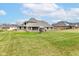 Spacious backyard featuring a well-maintained lawn and charming architecture of the home at 941 W Barouche, Pendleton, IN 46064