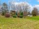 Spacious backyard with a swing set, storage shed, mature trees and lush landscaping at 941 W Barouche, Pendleton, IN 46064