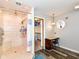 Accessible bathroom features a tiled shower, seat, grab bar and adjacent vanity area at 941 W Barouche, Pendleton, IN 46064
