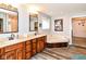 Elegant bathroom featuring double vanity sinks, a soaking tub, and wood-look flooring at 941 W Barouche, Pendleton, IN 46064