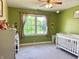 Cozy Bedroom with a crib, patterned curtains, green walls and Winnie the Pooh decor at 941 W Barouche, Pendleton, IN 46064