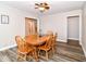 Inviting dining room offers wood-look floors, neutral walls, and an adjacent living area at 941 W Barouche, Pendleton, IN 46064