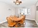 Cozy dining room features a wooden table, seating for six, ceiling fan and a bright window at 941 W Barouche, Pendleton, IN 46064