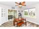 Cozy dining room with a wooden table, bench seating, sliding doors, and a modern ceiling fan at 941 W Barouche, Pendleton, IN 46064