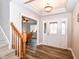 Inviting foyer with wood floors, a decorative front door, a staircase, and a view into the dining room at 941 W Barouche, Pendleton, IN 46064