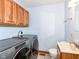 Laundry room with a washer, dryer, wooden cabinet and simple sink and faucet at 941 W Barouche, Pendleton, IN 46064