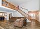 Spacious living room with high ceilings, wood floors, a staircase to a second floor, and lots of natural light at 941 W Barouche, Pendleton, IN 46064