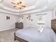 Spacious primary bedroom with a tray ceiling, gray dresser, and two windows at 941 W Barouche, Pendleton, IN 46064