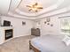 Spacious main bedroom boasts a tray ceiling, fireplace, and multiple windows for natural light at 941 W Barouche, Pendleton, IN 46064
