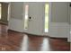 Entryway with traditional trim, hardwood floors, and a bright front door with sidelights at 9879 Brightwater Dr, Fishers, IN 46038