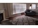 Cozy living room with fireplace, hardwood floors, and large windows; great natural light at 9879 Brightwater Dr, Fishers, IN 46038