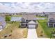 Aerial view of a two-story home with a lake view, manicured lawn, and a paved driveway at 991 Terra Ln, Franklin, IN 46131